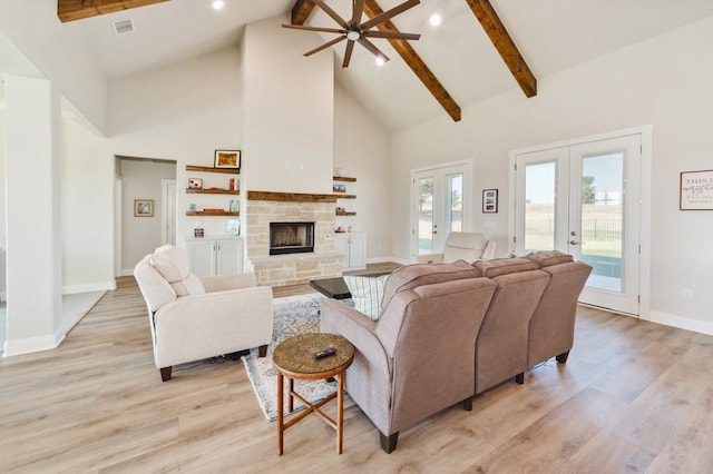 living room with french doors, beam ceiling, high vaulted ceiling, and light wood finished floors