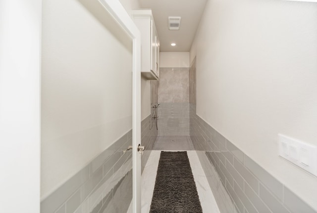 hallway featuring tile patterned flooring