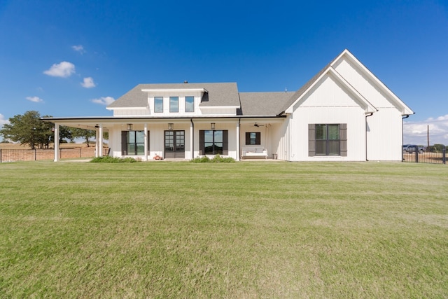 rear view of property with a lawn and a porch