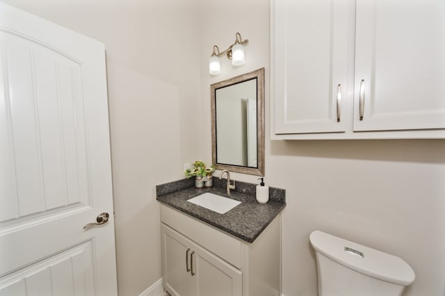 bathroom with toilet and vanity