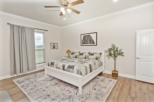 bedroom featuring light hardwood / wood-style flooring, ceiling fan, and crown molding