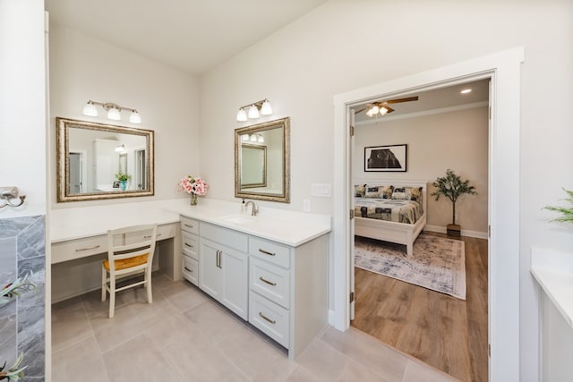 bathroom featuring hardwood / wood-style flooring, ceiling fan, and vanity