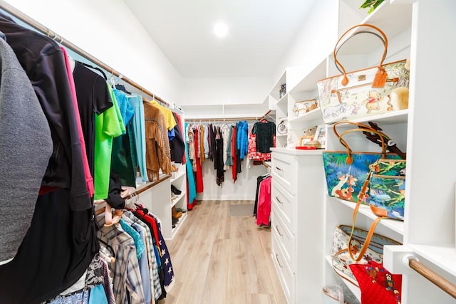 walk in closet with light wood-type flooring