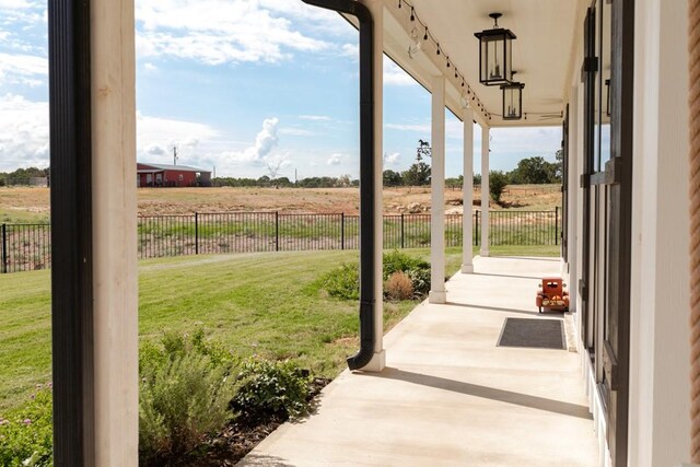 exterior space with ceiling fan, a lawn, and a patio area