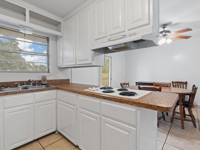 kitchen featuring light tile patterned floors, sink, ceiling fan, white electric stovetop, and white cabinets