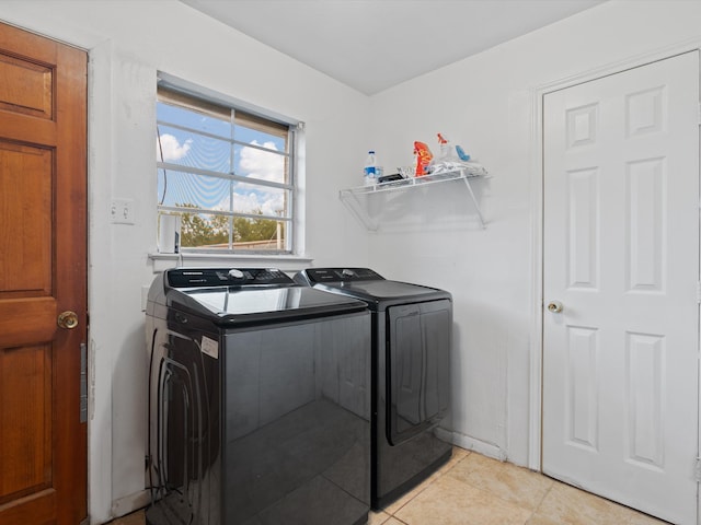 clothes washing area featuring separate washer and dryer and light tile patterned flooring