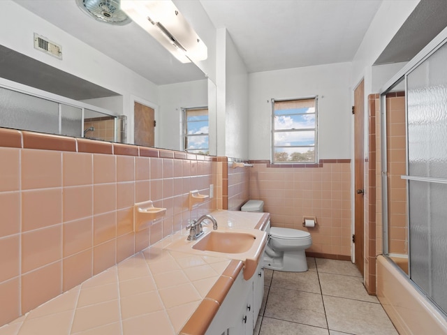 full bathroom with tile patterned flooring, toilet, tile walls, decorative backsplash, and vanity