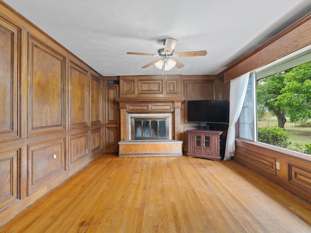 unfurnished living room featuring light hardwood / wood-style flooring and ceiling fan