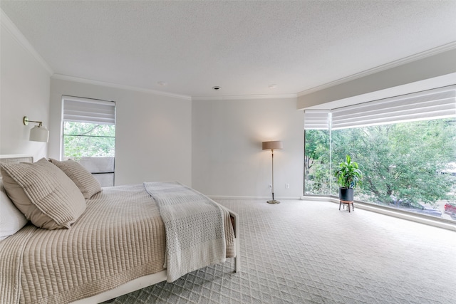 bedroom featuring a textured ceiling, ornamental molding, and carpet floors