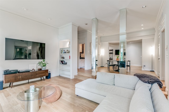 living room featuring light hardwood / wood-style flooring and ornamental molding