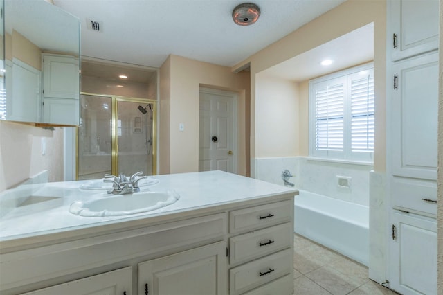 bathroom with independent shower and bath, vanity, and tile patterned floors