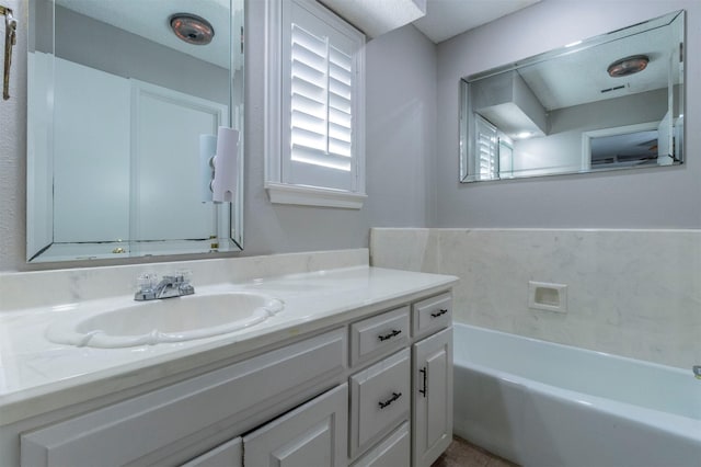 bathroom featuring vanity and a tub