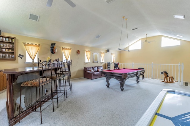 playroom with vaulted ceiling, pool table, light colored carpet, ceiling fan, and bar area