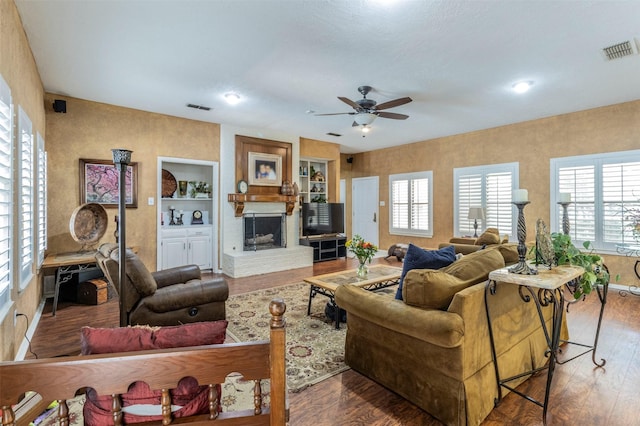 living room with ceiling fan, a healthy amount of sunlight, and dark hardwood / wood-style flooring