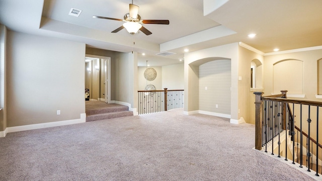 carpeted empty room featuring ceiling fan and ornamental molding