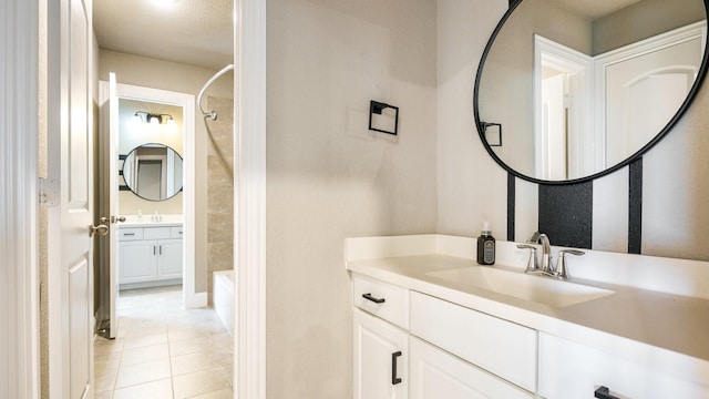 bathroom with tile patterned flooring, vanity, and washtub / shower combination