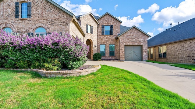 view of front of property with a front yard and a garage