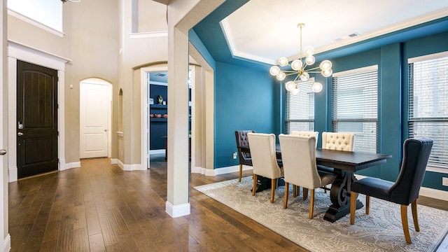 dining area featuring dark hardwood / wood-style flooring and a notable chandelier