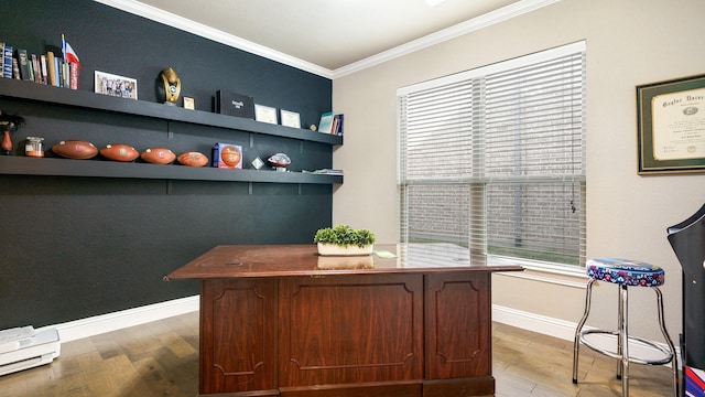 office area with built in shelves, hardwood / wood-style flooring, a baseboard heating unit, and ornamental molding