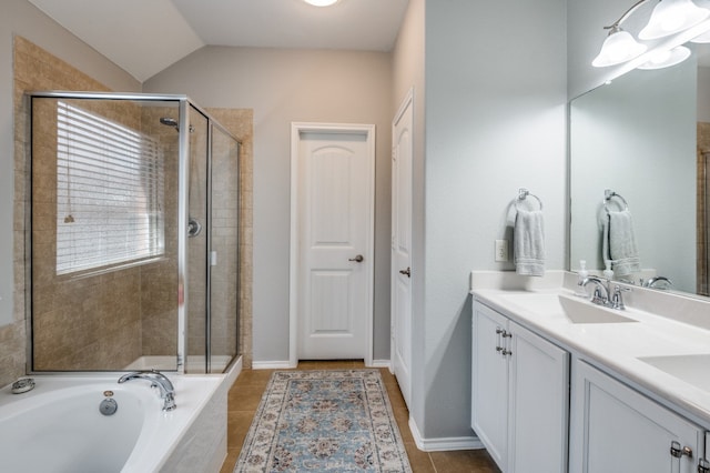 bathroom featuring plus walk in shower, tile patterned floors, vanity, and vaulted ceiling