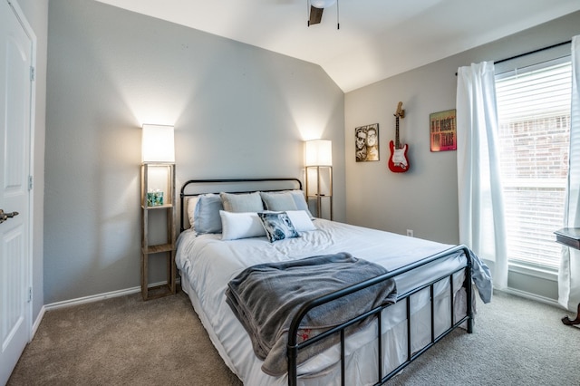 bedroom with vaulted ceiling, carpet floors, and multiple windows