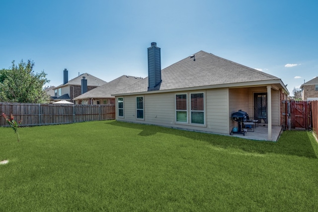 back of property featuring a yard and a patio area