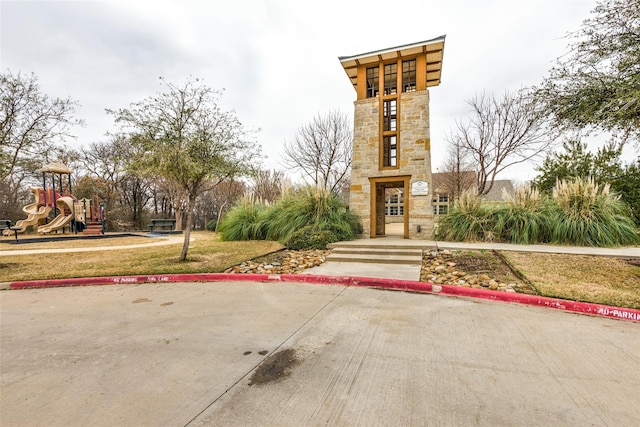 view of property's community featuring a playground and a yard