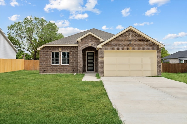 view of front of house with a front yard and a garage