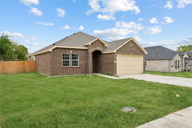 ranch-style house featuring a garage and a front yard