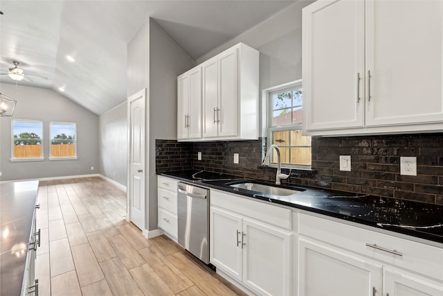 kitchen featuring vaulted ceiling, a healthy amount of sunlight, stainless steel dishwasher, and ceiling fan