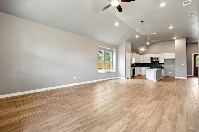 unfurnished living room featuring light wood-type flooring, high vaulted ceiling, and ceiling fan