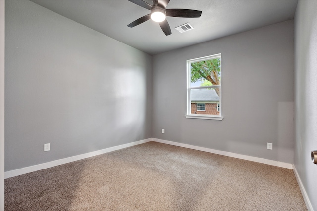 carpeted spare room featuring ceiling fan