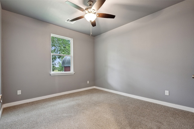 empty room featuring ceiling fan and carpet