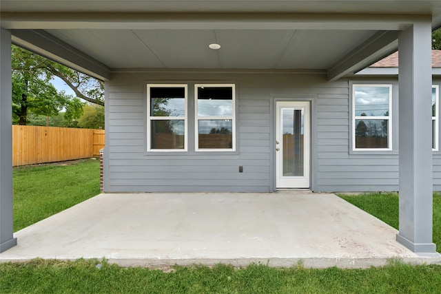 doorway to property featuring a yard and a patio area