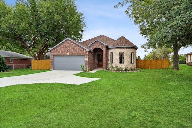 view of front of house with a garage and a front yard