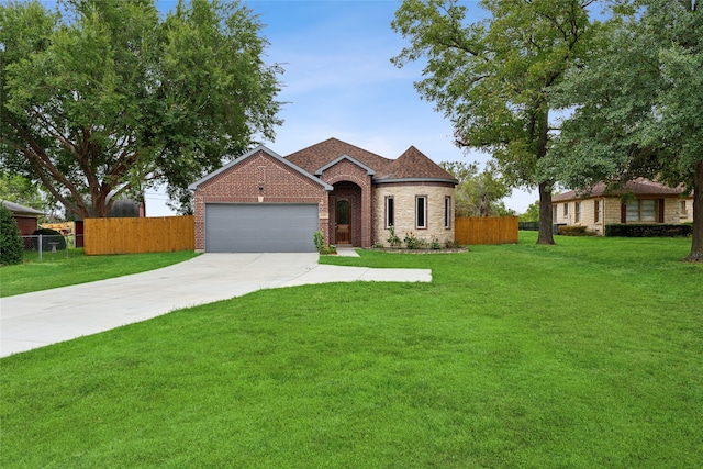 view of front of home featuring a garage and a front yard