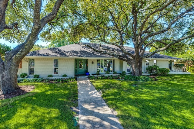 ranch-style home featuring a porch and a front lawn