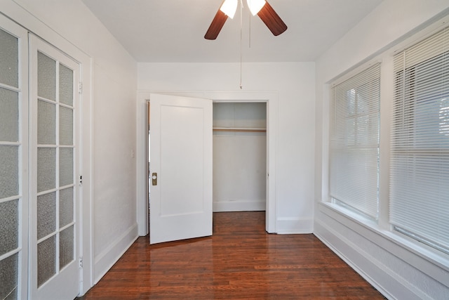 unfurnished bedroom featuring a closet, ceiling fan, and dark hardwood / wood-style flooring