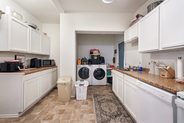 washroom with washing machine and clothes dryer and sink