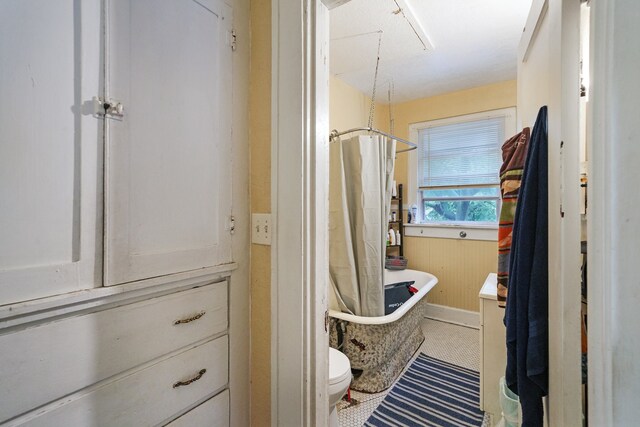 full bathroom featuring vanity, toilet, shower with separate bathtub, and wooden walls