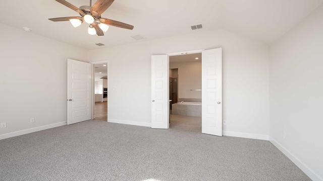 unfurnished bedroom featuring ceiling fan, ensuite bath, and carpet flooring