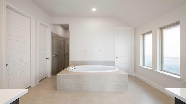 bathroom featuring lofted ceiling, tile patterned floors, separate shower and tub, and vanity