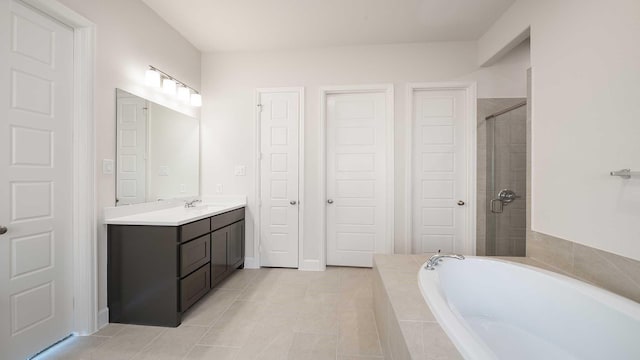 bathroom with independent shower and bath, vanity, and tile patterned flooring