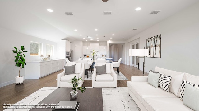 unfurnished living room featuring light hardwood / wood-style floors, ceiling fan, and vaulted ceiling