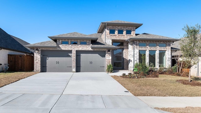 view of front of property with a front yard and a garage