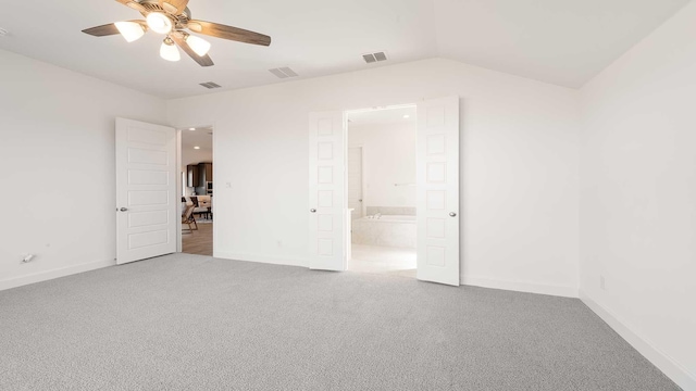 carpeted empty room with ceiling fan and lofted ceiling