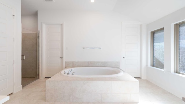 bathroom with tile patterned floors and independent shower and bath