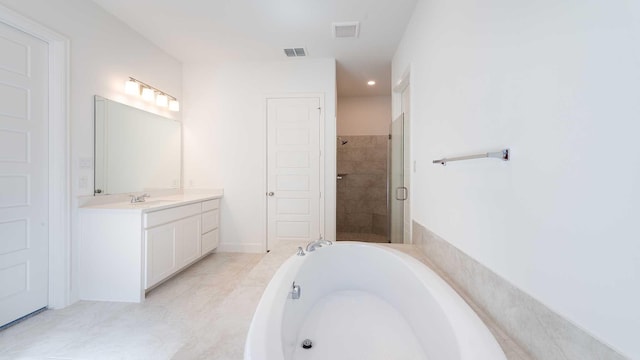 bathroom with tile patterned flooring, vanity, and separate shower and tub