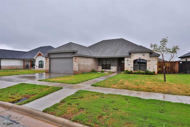 view of front of house featuring a garage and a front yard