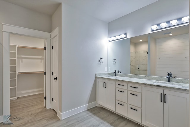 bathroom featuring vanity, hardwood / wood-style flooring, and an enclosed shower